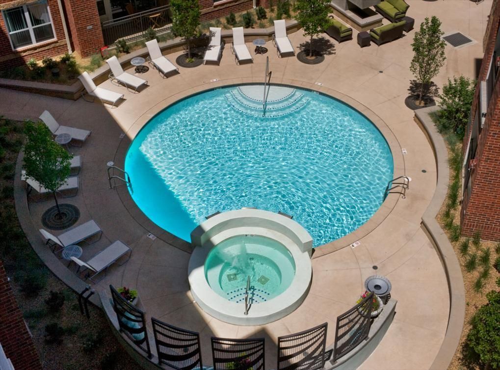 A round pool and spa in a courtyard, seen from above